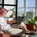 Work From Home Tips That Work Cozy home office corner with open laptop, coffee mug, and notebook in warm morning light